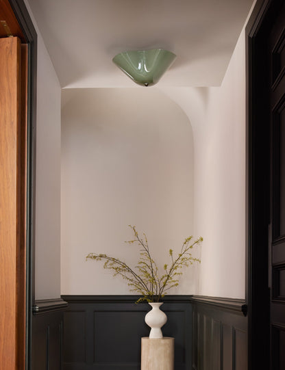 Radner Flush Mount Light styled in a room