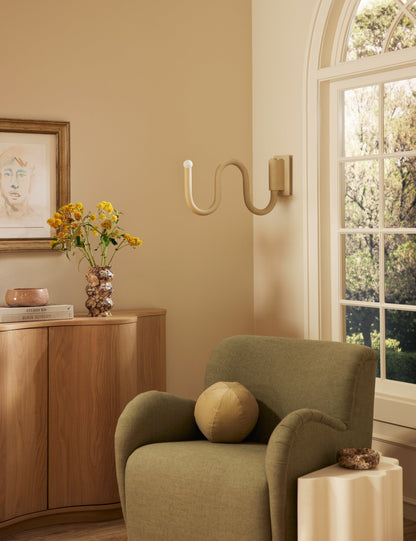 Noor Swing Arm Sconce bedroom wall light in a styled room